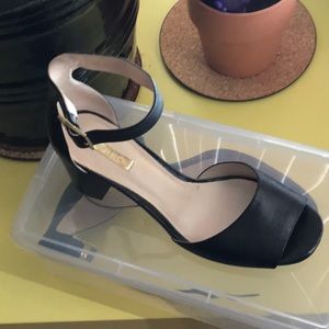 Black ankle strap toe out shoes
